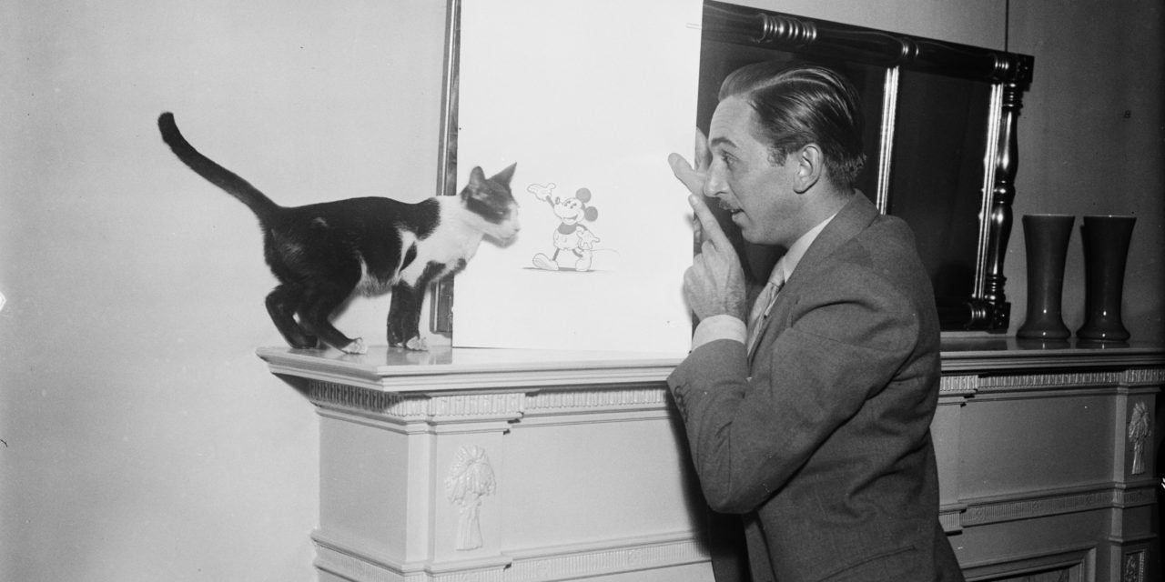 Walt Disney Showing a Picture of Mickey Mouse to a Cat